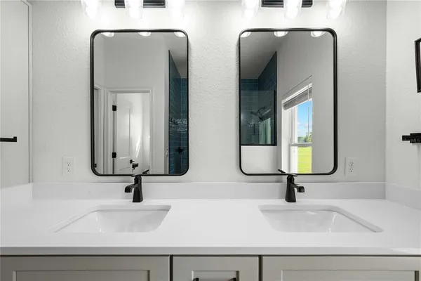 a bedroom with bed and a chandelier