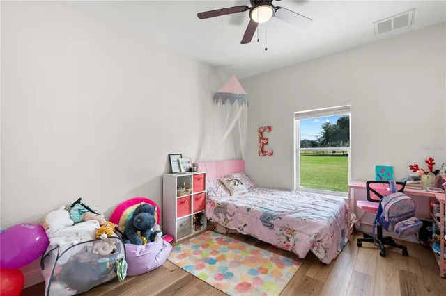 a bedroom with bed and a book shelf