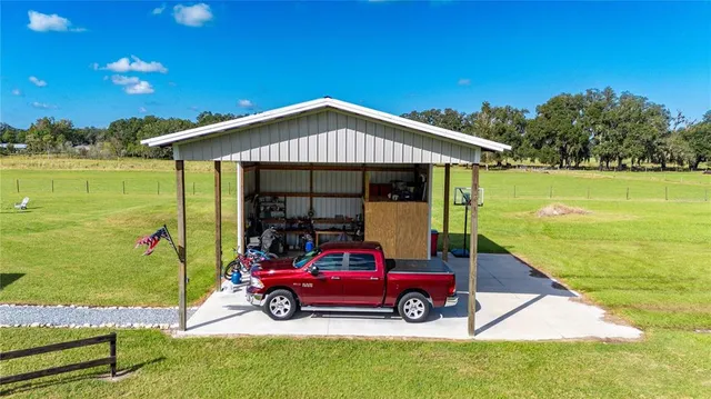 a view of an house with pool and a yard
