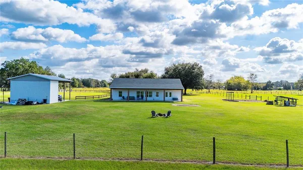 a view of a dining room with furniture wooden floor and chandelier