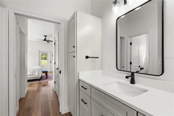 a bedroom with a bed a dresser and chair