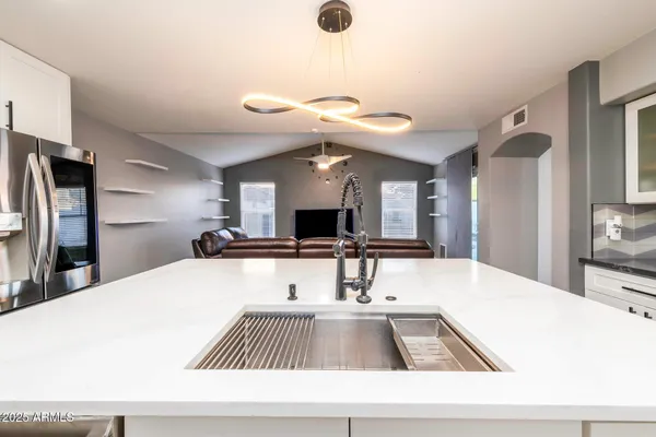 a view of kitchen with a refrigerator and a sink
