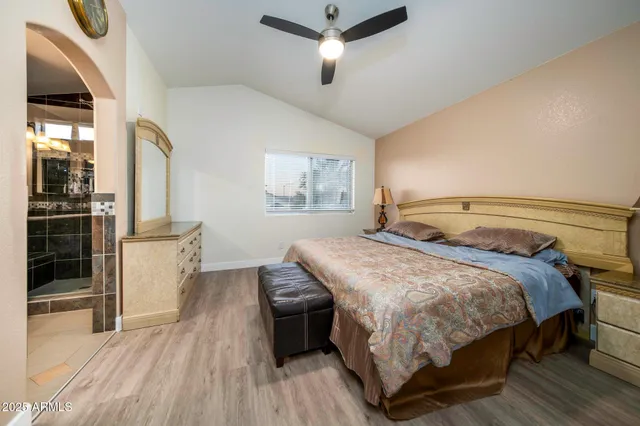 a bedroom with a bed and wooden floor