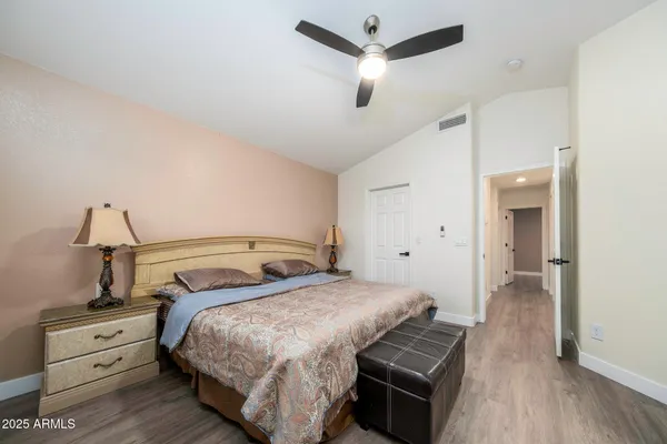 a bedroom with a bed and a chandelier