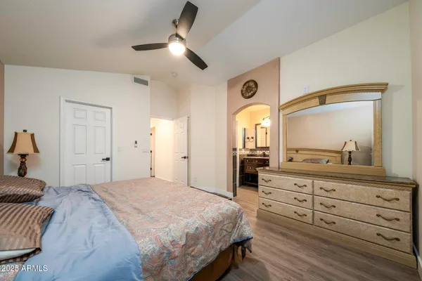 a bedroom with a bed and a dresser