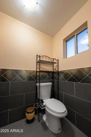 a white toilet sitting next to a bathroom sink