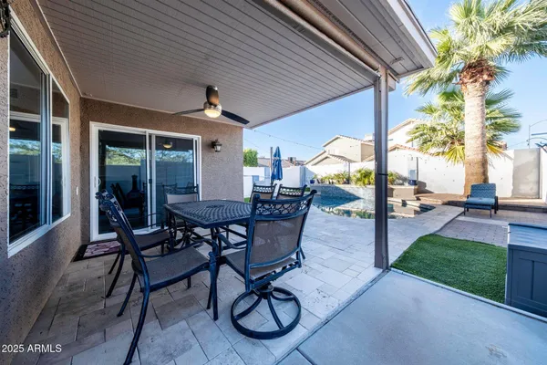 a view of a patio with table and chairs and potted plants
