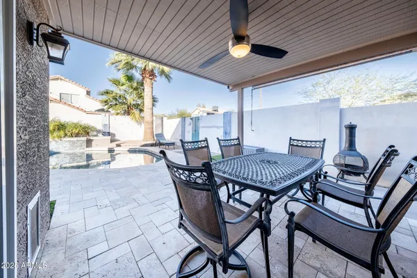 a view of a patio with a table and chairs