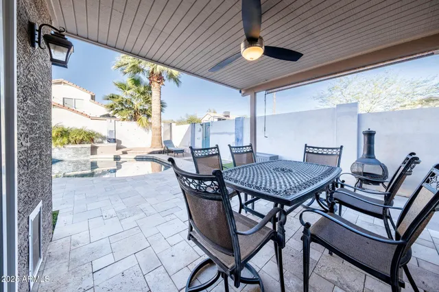 a view of a patio with a table and chairs