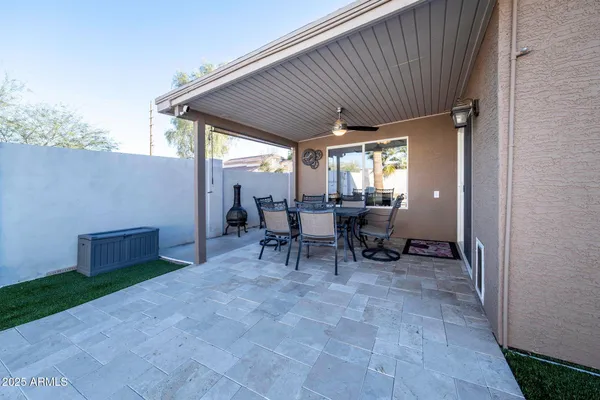 a view of a patio with table and chairs and potted plants