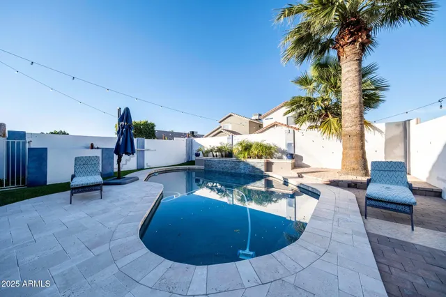 a swimming pool with outdoor seating