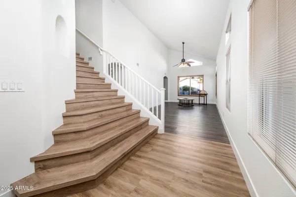 a view of entryway and hall with wooden floor