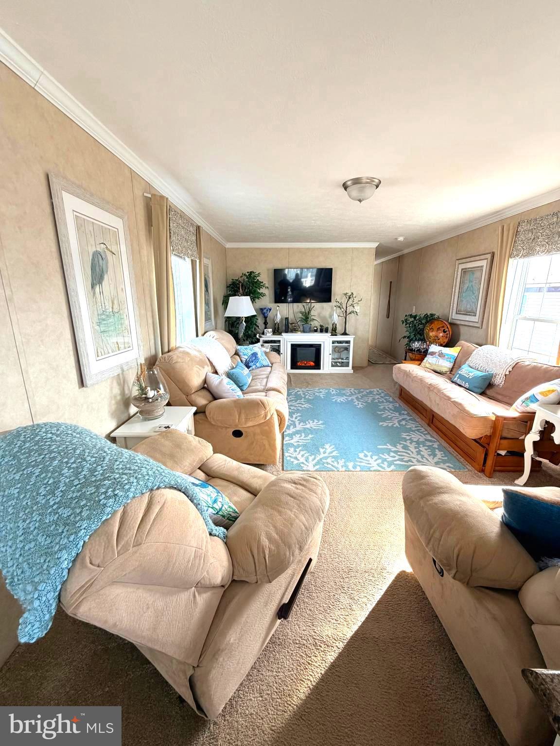 38025 Rabbit Road, Unit 101 Ocean View, DE 19970 - Photo 31 of 112 a living room with furniture and a large window