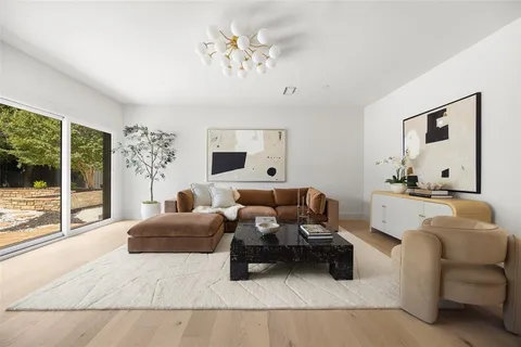 a bedroom with furniture and a large window