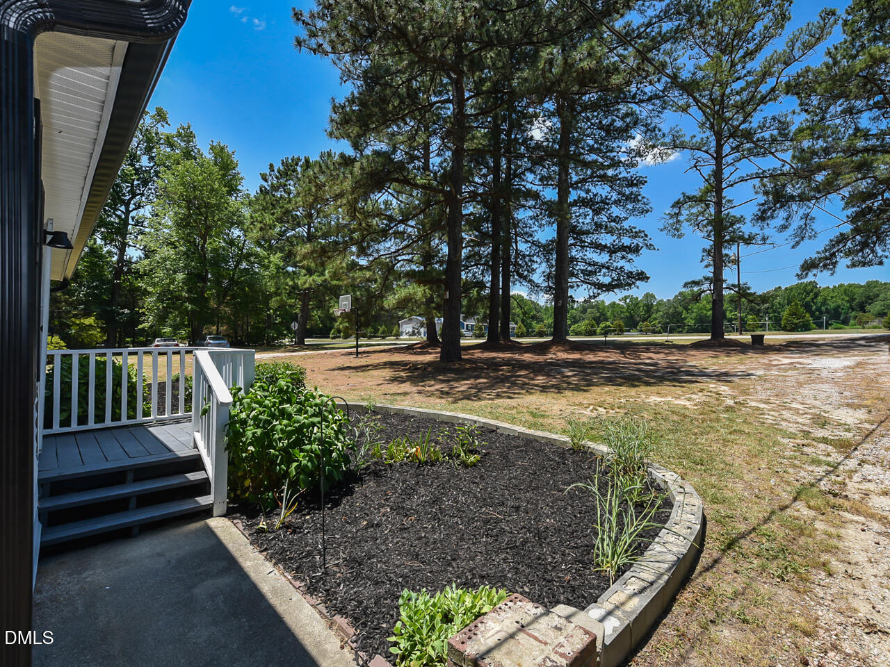 939 Cheves Road Zebulon, NC 27597 - Photo 3 of 21 a view of a backyard with large trees