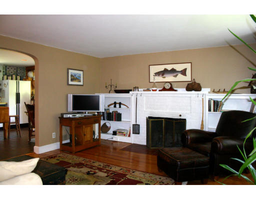 131 Concord Road Wayland, MA 01778 - Photo 2 of 14 a living room with furniture a flat screen tv and a fireplace