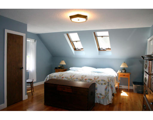 131 Concord Road Wayland, MA 01778 - Photo 9 of 14 a bedroom with a bed and a chandelier