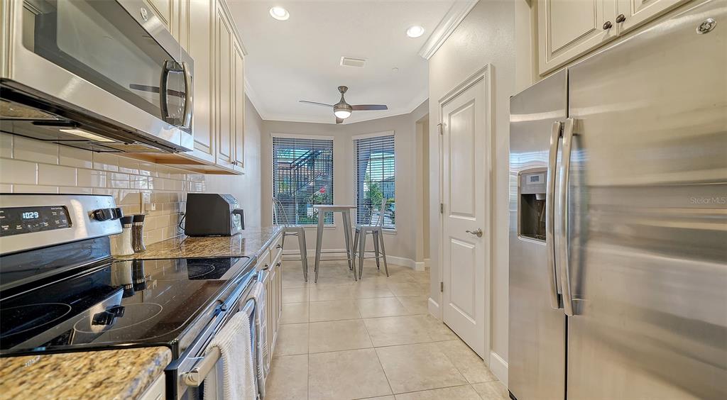13604 Messina Loop, Unit 103 Bradenton, FL 34211 - Photo 11 of 97 a kitchen with stainless steel appliances a refrigerator and a stove top oven