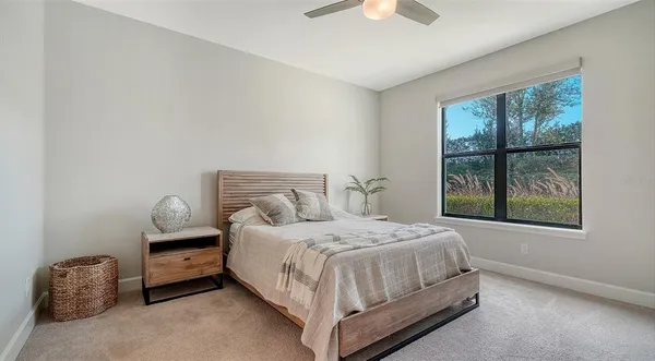 a living room with furniture and a floor to ceiling window