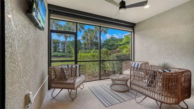 a living room with fireplace furniture flat screen tv and wooden floor