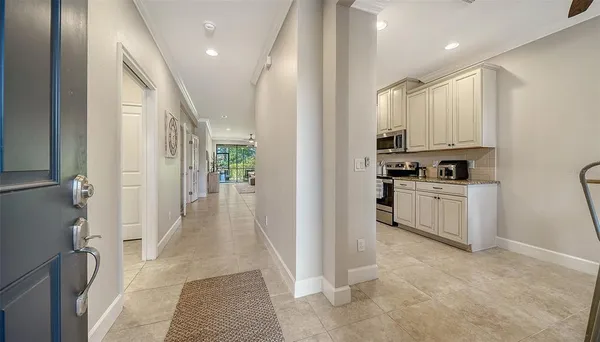 a view of living room kitchen with stainless steel appliances granite countertop furniture and a window