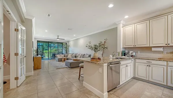 a kitchen with stainless steel appliances granite countertop a stove sink and cabinets