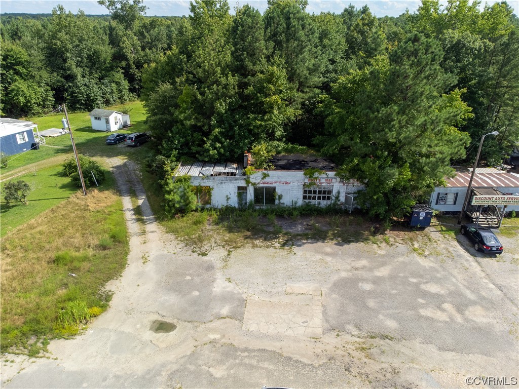 18619 Hull Street Road Moseley, VA 23120 - Photo 5 of 23 a view of a patio with table and chairs potted plants and large trees