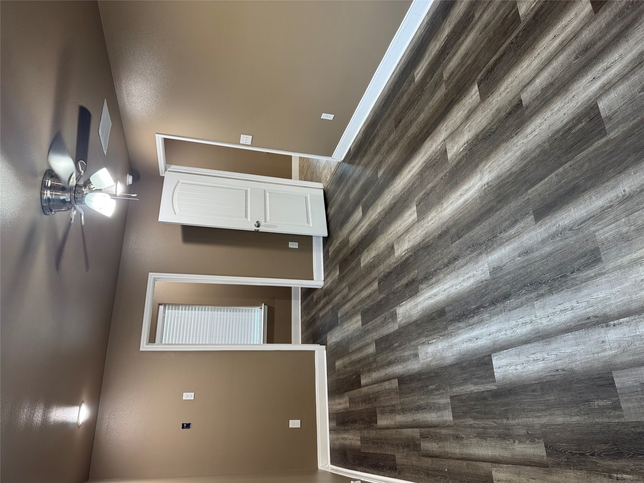 5706 Melody Lane, Unit 2 Austin, TX 78724 - Photo 7 of 13 wooden floor in an empty room with a window