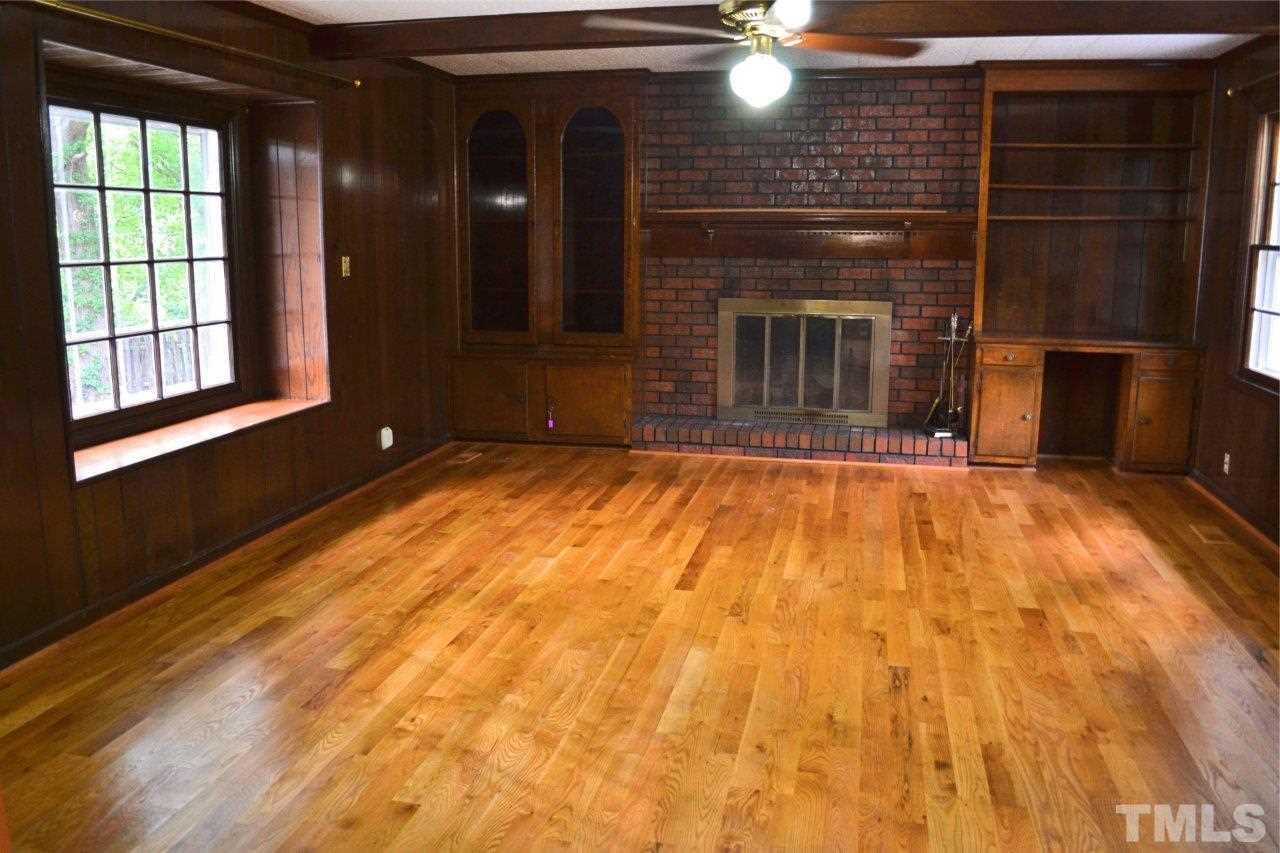 2709 Ramsey Road Raleigh, NC 27604 - Photo 2 of 6 a view of empty room with a fireplace and wooden floor