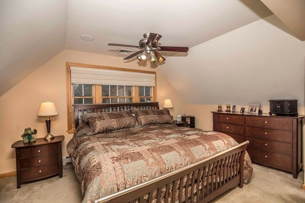 11 Hampton Road Sharon, MA 02067 - Photo 14 of 27 a bedroom with a bed and a chandelier