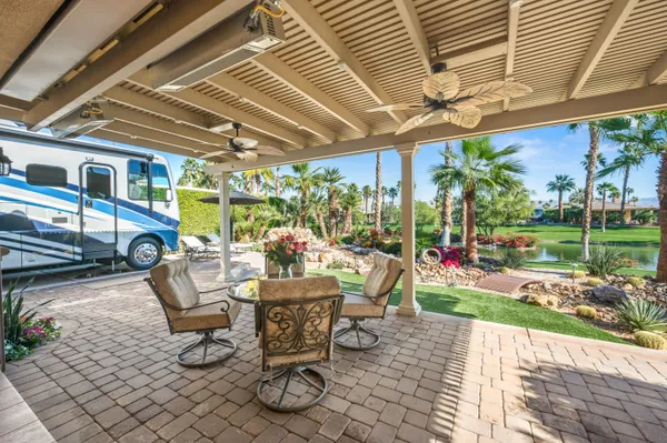 a view of a patio with table and chairs and potted plants