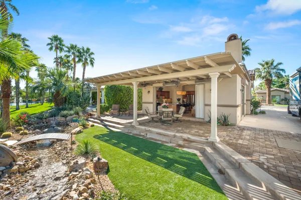 a living room with furniture a flat screen tv and a large window