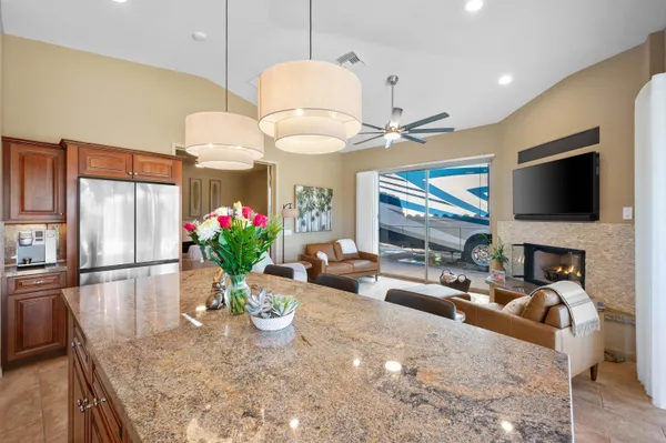 a bathroom with a granite countertop sink a toilet and a mirror