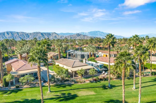 a living room with patio furniture and a wooden floor