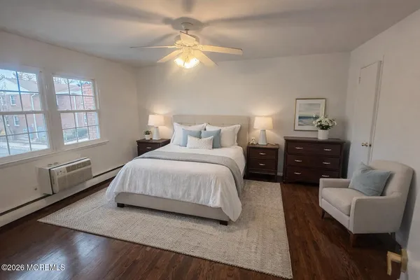 a view of a room with wooden floor and a window
