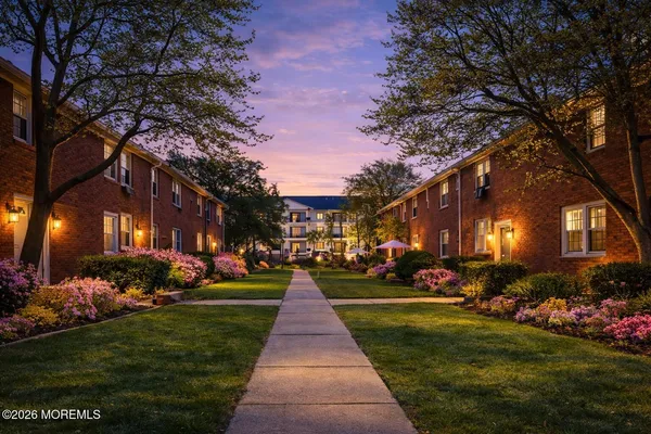 a front view of a building with a garden