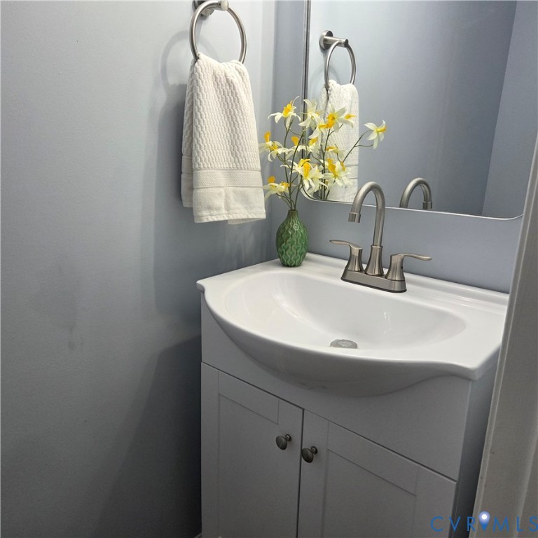 3241 Ransom Hills Road Richmond, VA 23237 - Photo 13 of 24 White vanity with cabinet storage, integrated basi