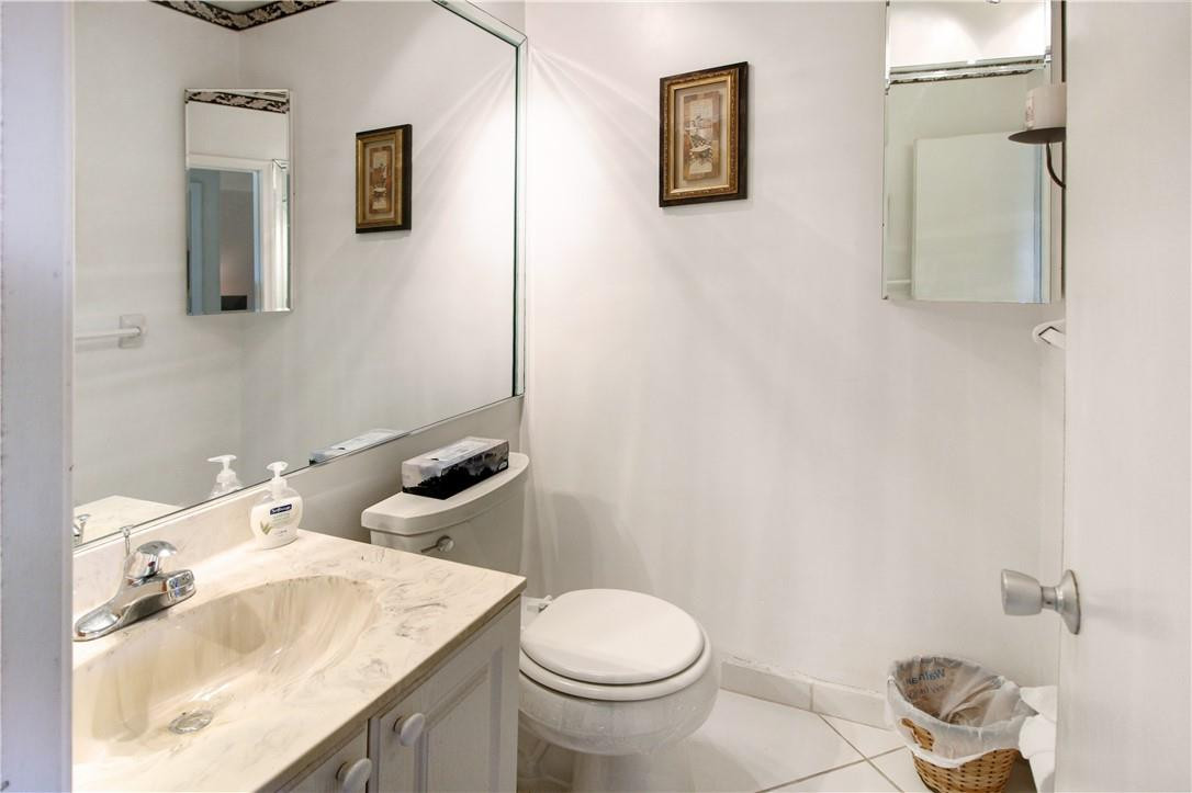2100 Northeast 38th Street, Unit 222 Lighthouse Point, FL 33064 - Photo 15 of 21 a bathroom with a granite countertop toilet sink and mirror
