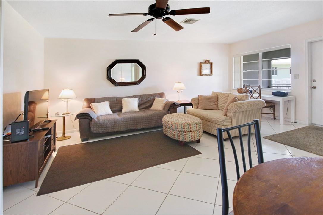 2100 Northeast 38th Street, Unit 222 Lighthouse Point, FL 33064 - Photo 7 of 21 a living room with furniture and a window