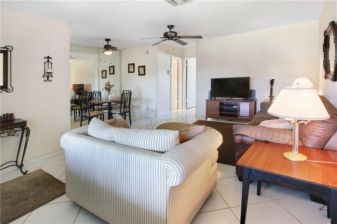 2100 Northeast 38th Street, Unit 222 Lighthouse Point, FL 33064 - Photo 8 of 21 a living room with furniture and a flat screen tv