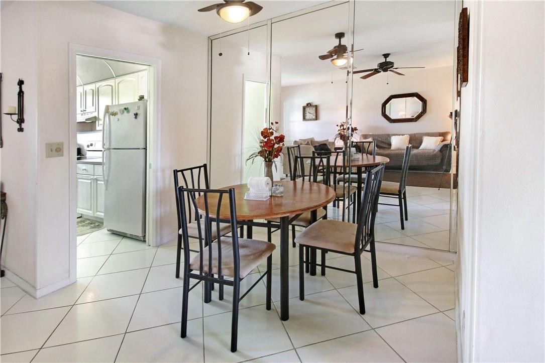 2100 Northeast 38th Street, Unit 222 Lighthouse Point, FL 33064 - Photo 10 of 21 a view dining room with furniture and chandelier