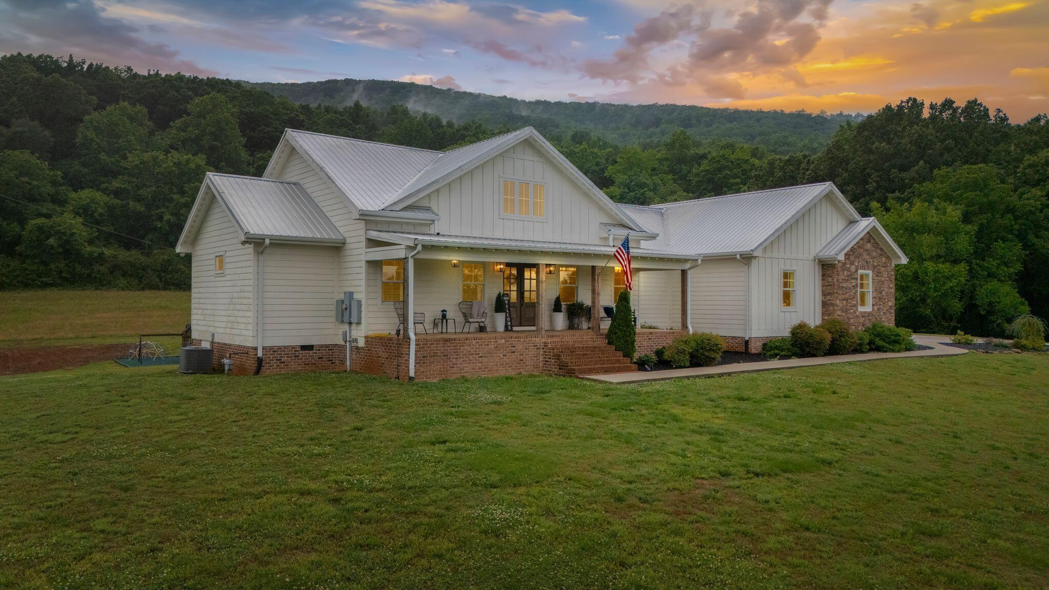 6866 Daus Mountain Road Whitwell, TN 37397 - Photo 1 of 49 a front view of a house with a yard and garage