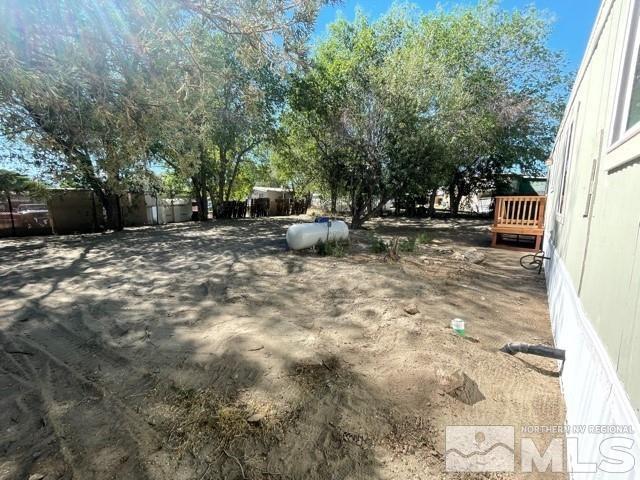 3625 Hummingbird Drive Reno, NV 89508 - Photo 16 of 18 a view of a backyard with table and chairs and a large tree