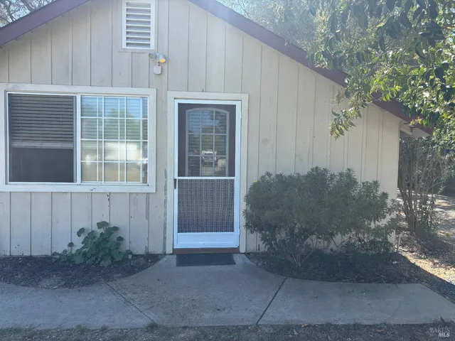 a view of a house with a backyard