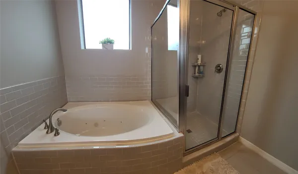 a bathroom with a granite countertop sink a mirror and a bathtub