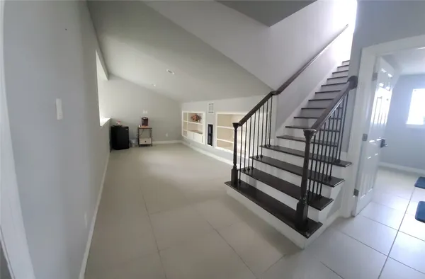 a bedroom with a bed a couch and a window