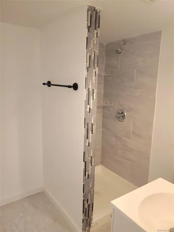 a bathroom with a shower and a sink