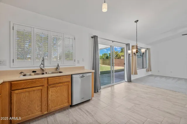 a kitchen with kitchen island a counter top a stove a sink and a refrigerator