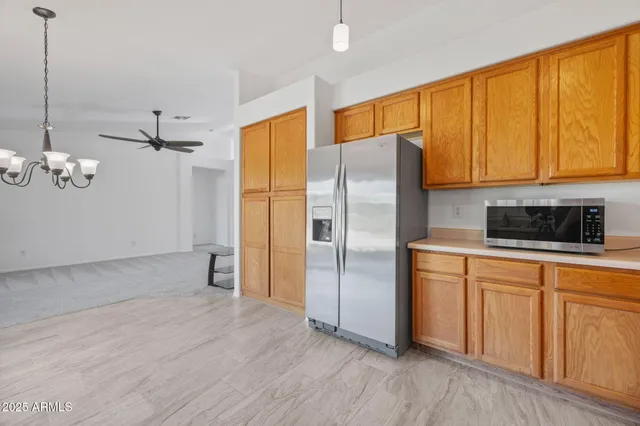 a kitchen with granite countertop stainless steel appliances and wooden cabinets