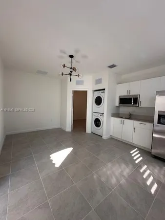 a view of a kitchen with a sink and cabinets